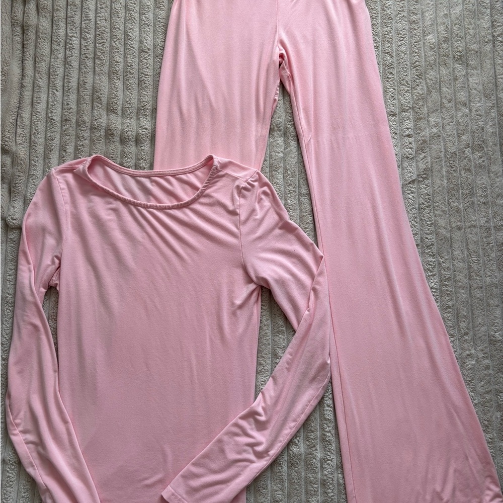 Pink matching long sleeve top and flare leggings set